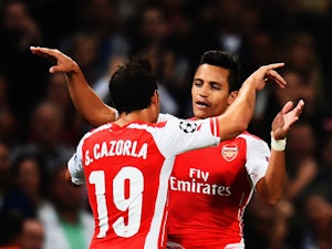 Sanchez sends 10-man Arsenal through