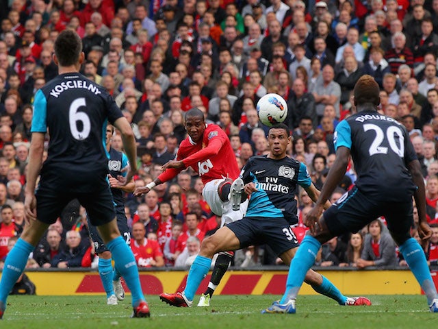 Ashley Young of Manchester United curls the ball and scores his side's second goal during the Barclays Premier League match against Arsenal on August 28, 2011