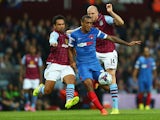 Kieran Richardson of Aston Villa and Jay Simpson of Leyton Orient vie for the ball during the Capital One Cup second round match between Aston Villa and Leyton Orient at Villa Park on August 27, 2014