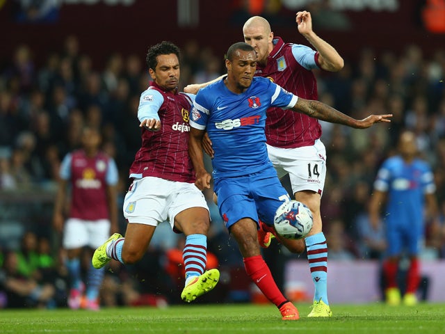 Kieran Richardson of Aston Villa and Jay Simpson of Leyton Orient vie for the ball during the Capital One Cup second round match between Aston Villa and Leyton Orient at Villa Park on August 27, 2014