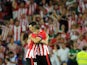 Athletic Bilbao's forward Aritz Aduriz celebrates with his teammate forward Iker Muniain (L) after scoring during the UEFA Champions League play-off second leg football match Athletic Bilbao vs SSC Napoli at the San Mames stadium in Bilbao on August 27, 2