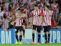 Athletic Bilbao's forward Aritz Aduriz celebrates with his teammates after scoring his second goal during the UEFA Champions League play-off second leg football match Athletic Bilbao vs SSC Napoli at the San Mames stadium in Bilbao on August 27, 2014
