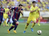 Barcelona's Argentinian forward Lionel Messi vies with Villarreal's midfielder Manuel Trigueros Munoz during the Spanish league football match Villarreal vs Barcelona at the Camp El Madrigal stadium in Villareal on August 31, 2014