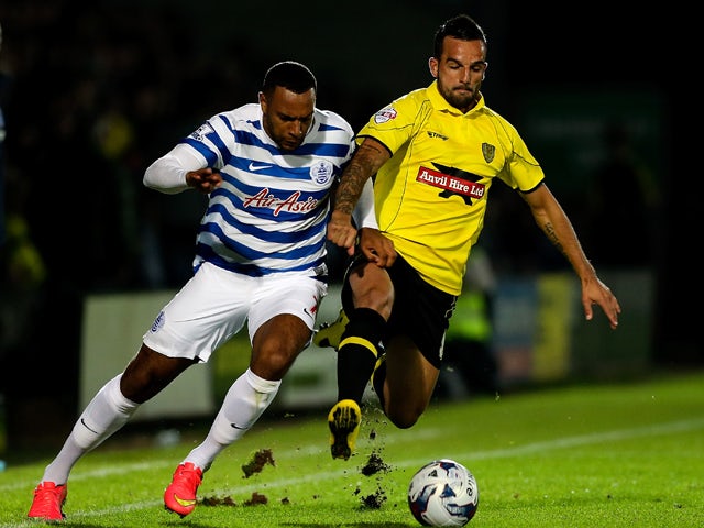  Robbie Weir of Burton tackles Matt Phillips of QPR during the Capital One Cup Second Round match between Burton Albion and Queens Park Rangers at Pirelli Stadium on August 27, 2014