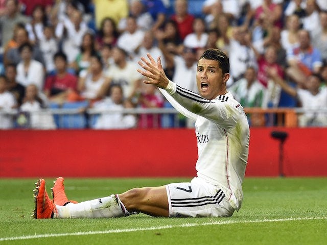 A frustrated Cristiano Ronaldo sits on the pitch during Real Madrid's encounter with Cordoba on August 25, 2014