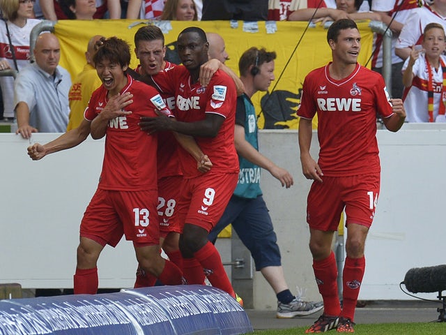 FC Koln's Japanese forward Yuya Osako, Austrian defender Kevin Wimmer, Nigerian forward Anthony Ujah and defender Jonas Hector celebrate after Osako scored the opening goal during the German first division Bundesliga football match VfB Stuttgart vs 1 FC K