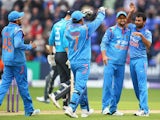 Mohammed Shami of India celebrates with Suresh Raina and MS Dhoni after capturing the wicket of Alastair Cook of England during the second Royal London One-Day Series match between England and India at the SWALEC Stadium on August 27, 2014