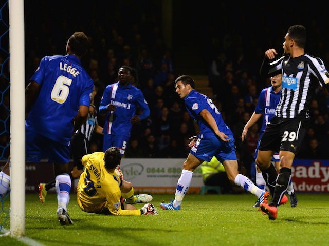 John Egan of Gillingham scores an own goal during the Capital One Cup second round match against Newcastle United on August 26, 2014