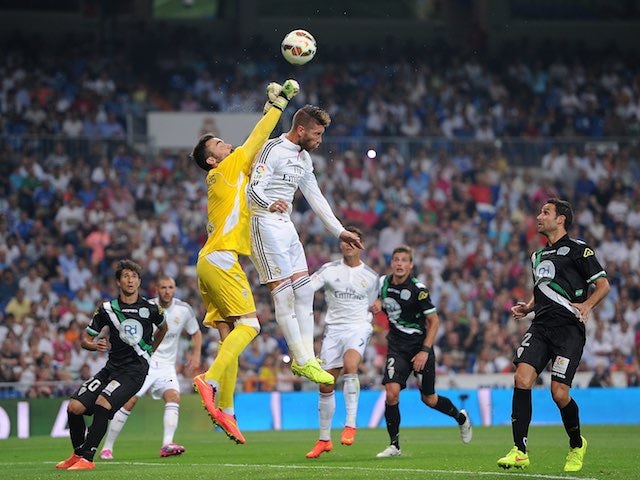 Cordoba keeper Juan Carlos rises high above Sergio Ramos on August 25, 2014