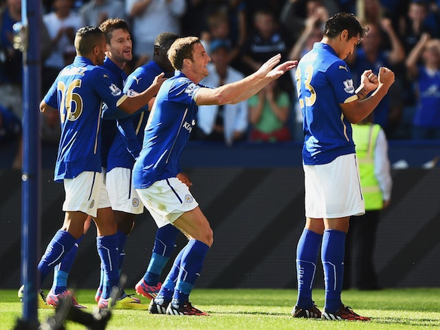 Leonardo Ulloa (R) of Leicester City celebrates scoring his team's opening goal with team mates during the Barclays Premier League match against Arsenal on August 2014, 2014