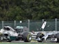 Mercedes-AMG's British driver Lewis Hamilton (L) and and Mercedes-AMG's German driver Nico Rosberg collide at the Spa-Francorchamps ciruit in Spa on August 24, 2014