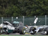 Mercedes-AMG's British driver Lewis Hamilton (L) and and Mercedes-AMG's German driver Nico Rosberg collide at the Spa-Francorchamps circuit in Spa on August 24, 2014