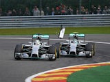 Mercedes-AMG's British driver Lewis Hamilton (L) and and Mercedes-AMG's German driver Nico Rosberg collide at the Spa-Francorchamps ciruit in Spa on August 24, 2014