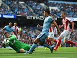 Sergio Aguero of Manchester City has a shot saved by Asmir Begovic of Stoke City during the Barclays Premier League match between Manchester City and Stoke City at Etihad Stadium on August 30, 2014