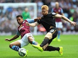 Hull City player Paul McShane (r) challenges Kieran Richardson of Villa during the Barclays Premier League match on August 31, 2014