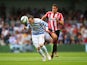 Jordan Mutch of QPR heads the ball under pressure from Jack Rodwell of Sunderland during the Barclays Premier League match between Queens Park Rangers and Sunderland at Loftus Road on August 30, 2014