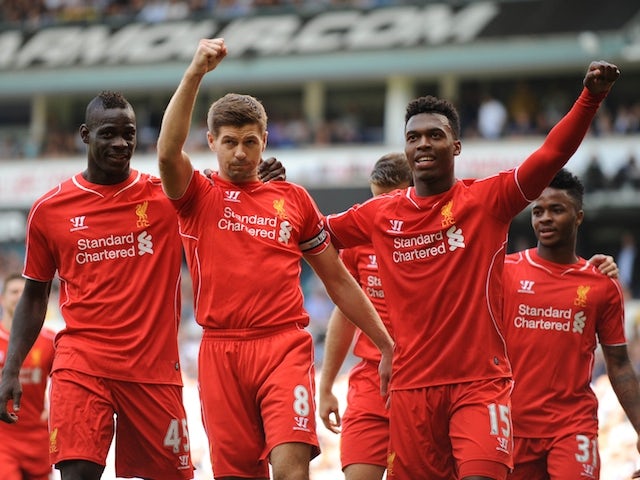 Liverpool's English midfielder Steven Gerrard (R) celebrates scoring a penalty against Tottenham on August 31, 2014