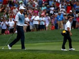 Tiger Woods of the United States smiles alongside golf instructor Sean Foley during a practice round prior to the start of the 96th PGA Championship at Valhalla Golf Club on August 6, 2014