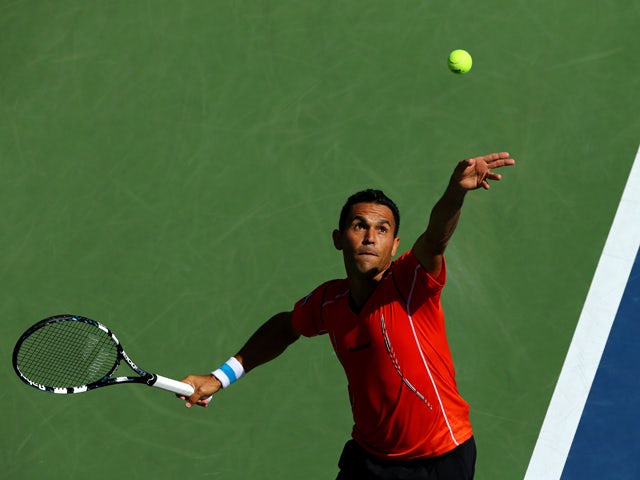 Victor Estrella Burgos of the Dominican Republic serves to Milos Raonic of Canada during their men's singles third round match on Day Six of the 2014 US Open at the USTA Billie Jean King National Tennis Center on August 30, 2014