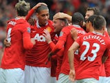 Manchester United's English striker Wayne Rooney (3rd L) celebrates with team-mates after scoring during the English Premier League football match against Arsenal on August 28, 2011