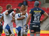 Anthony Watson of Bath Rugby celebrates with team mates after scoring his teams first try as Michael Paterson of Sale looks on during the Aviva Premiership match on September 6, 2014