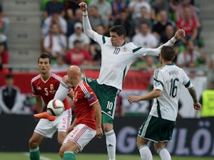 North Ireland's forward Kyle Lafferty and midfielder Oliver Norwood vies for the ball with Hungary's defender Zoltan Liptak and midfielder Jozsef Varga during the UEFA Euro 2016 Group F qualifying match Hungary vs Northern Ireland on September 7, 2014