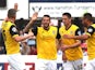 Marc Richards of Northampton Town celebrates with team mates after scoring his sides 1st goal during the Sky Bet League Two match against Dagenham & Redbridge on September 6, 2014