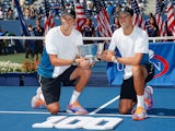 Mike Bryan and Bob Bryan of United States pose with the champions trophy after their 100th career title win at the US Open on September 7, 2014
