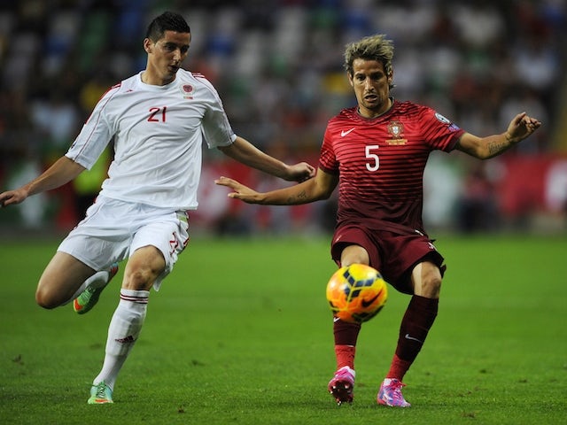 Albania's forward Odise Roshi (L) vies with Portugal's defender Fabio Coentrao during the UEFA Euro 2016 qualifying football match on September 7, 2014