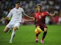 Albania's forward Odise Roshi (L) vies with Portugal's defender Fabio Coentrao during the UEFA Euro 2016 qualifying football match on September 7, 2014