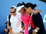 Shuai Peng of China is tended to by trainers after getting injured while playing against Caroline Wozniacki of Denmark during their women's singles semifinal match on Day Twelve of the 2014 US Open at the USTA Billie Jean King National Tennis Center on Se