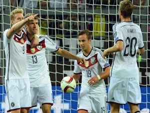 Germany's midfielder Thomas Mueller (2nd L) celebrates with his teammates Andre Schuerrle and Mario Goetze on Septemeber 7, 2014