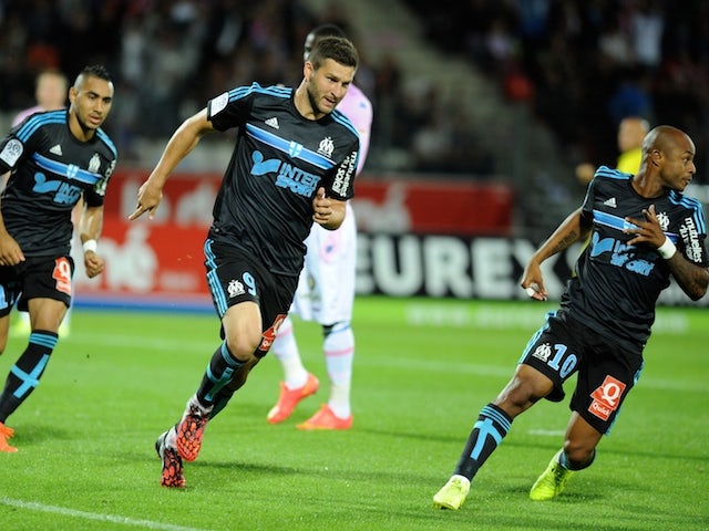 Marseille's French forward Andre-Pierre Gignac (C) celebrates after scoring a goal during the French L1 football match Evian (ETG) against Marseille (OM) on September 14, 2014 