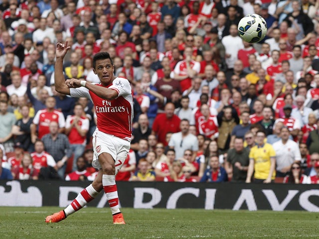 Arsenal's Chilean striker Alexis Sanchez shoots to score during the English Premier League football match between Arsenal and Manchester City at the Emirates Stadium in London on September 13, 2014