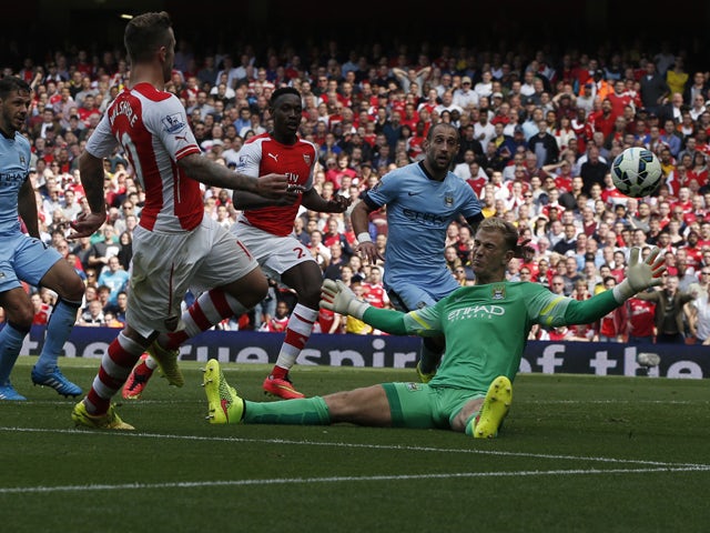 Arsenal's English midfielder Jack Wilshere scores an equalising goal past Manchester City's English goalkeeper Joe Hart bringing the score to 1-1 during the English Premier League football match between Arsenal and Manchester City at the Emirates Stadium 