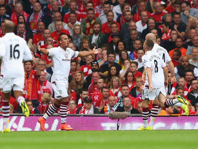 Gabriel Agbonlahor of Aston Villa celebrates scoring the opening goal during the Barclays Premier League match between Liverpool and Aston Villa at Anfield on September 13, 2014