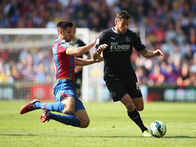 Lukas Jutkiewicz of Burnley is challenged by Scott Dann of Crystal Palace during the Barclays Premier League match between Crystal Palace and Burnley at Selhurst Park on September 13, 2014