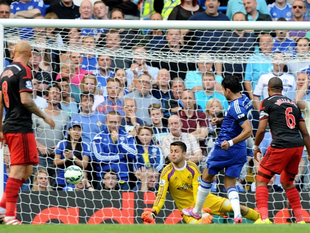 Chelsea's Brazilian-born Spanish striker Diego Costa scores his third goal during the English Premier League football match between Chelsea and Swansea City at Stamford Bridge in London on September 13, 2014
