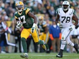 Wide receiver Davante Adams #17 of the Green Bay Packers runs with the football after receiving a 24 yard pass ahead of defensive tackle Leger Douzable on September 14, 2014