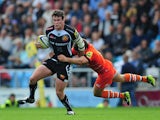 Ian Whitten of Exeter Chiefs is tackled by Anthony Allen of Leicester Tigers during the Aviva Premiership match between Exeter Chiefs and Leicester Tigers at Sandy Park on September 13, 2014