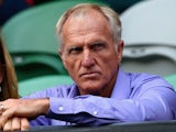 Golfer Greg Norman watches Andy Murray of Great Britain and Roger Federer of Switzerland in their semifinal match during day twelve of the 2013 Australian Open on January 13, 2013