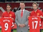 Manchester United's Dutch manager Louis van Gaal (C) poses for photographs along with the club's latest signings Colombian striker Radamel Falcao (L) and Dutch midfielder Daley Blind on September 11, 2014