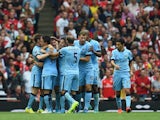 Martin Demichelis of Manchester City is congratulated by team-mates after scoring during the Barclays Premier League match between Arsenal and Manchester City at Emirates Stadium on September 13, 2014