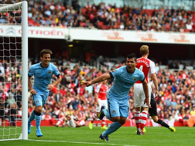 Sergio Aguero of Manchester City celebrates scoring the opening goal during the Barclays Premier League match between Arsenal and Manchester City at Emirates Stadium on September 13, 2014 