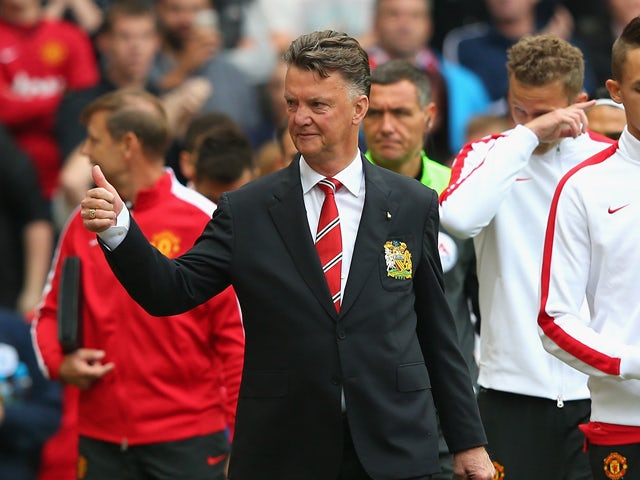 Manchester United Manager Louis van Gaal gives a thumbs up prior to the Barclays Premier League match between Manchester United and Queens Park Rangers at Old Trafford on September 14, 2014
