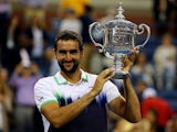 Marin Cilic of Croatia poses with the trophy after winning the US Open at Flushing Meadows, New York on September 8, 2014