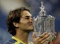 Roger Federer of Switzerland kisses the championship trophy after defeating Andre Agassi in the men's final of the US Open at the USTA National Tennis Center in Flushing Meadows Corona Park on September 11, 2005