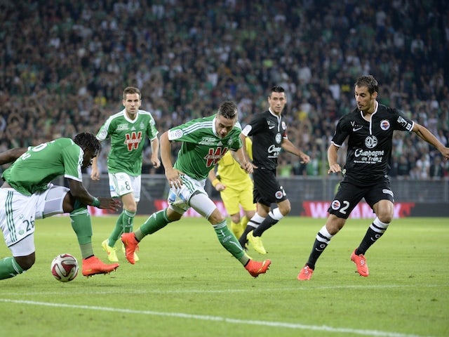 Saint Etienne's French midfielder Romain Hamouma (C) and Saint Etienne's Senegalese defender Moustapha Bayal Sall (L) vie for the ball with Caen's French midfielder Nicolas Seube on September 13, 2014