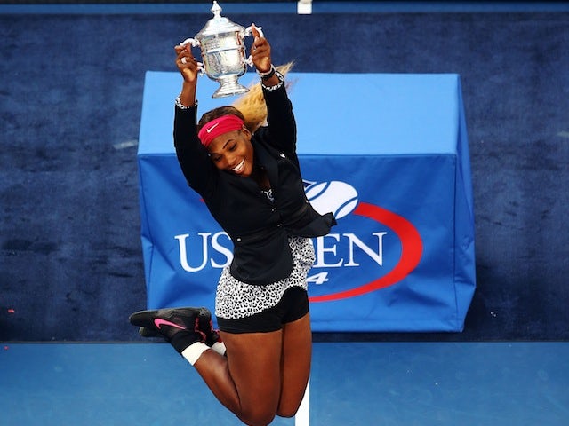 Serena Williams jumps for joy with the trophy after winning the US Open in New York on September 7, 2014