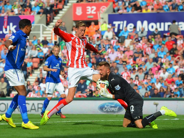 Ben Hamer of Leicester City makes a save from Peter Crouch of Stoke City during the Barclays Premier League match between Stoke City and Leicester City at Britannia Stadium on September 13, 2014 